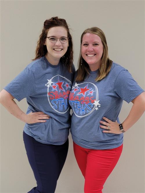 The Skaggs PACE Team, Sarah Tudor and Kyla Ahnemann, smiling in their soft blue team shirts.
